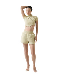 Woman wearing a light-colored outfit on a white background